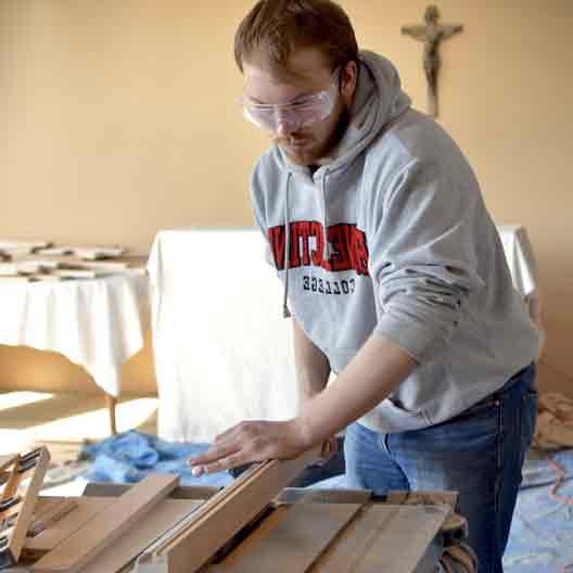 A student works at a table saw